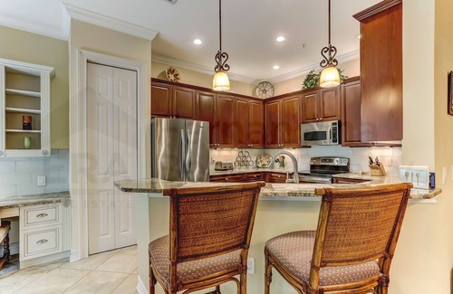 American Beach Condo | Nestled in a sancutary of beautiful trees in gated Villas at Summer Beach. Ground Floor unit.