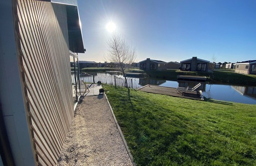 Municipality of Kampen House | NEW Elegant waterfront chalet with jetty Lake Kampen Netherlands vacation home boat