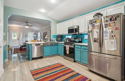 Kyle House | NEW LISTING! Eclectic Oasis: Artful & Colorful Comfort by RedAwning