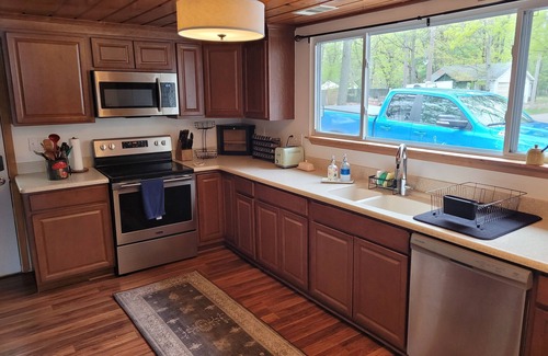 National City House | New! Seven Oaks at Bass Lake - Beautiful Lakefront Getaway with Dock and Canoe!