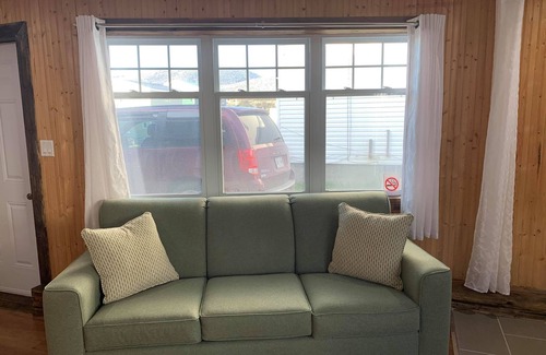 Trout River House | Ocean Breeze offers modern amenities in a renovated saltbox house.