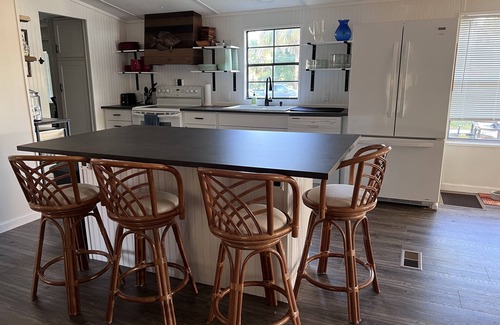 Suwannee House | Old Florida Waterfront Getaway - Large Porch, Big Dock, & Pet Friendly