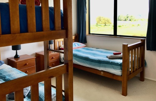 Pohara House | Only steps from the beach. Roomy, relaxed family fun. Good old Kiwi bach.
