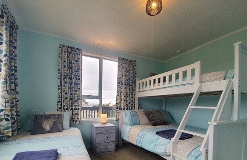 Opito Bay House | Opito Bay Charmer - Sun drenched family bach is a real charmer.