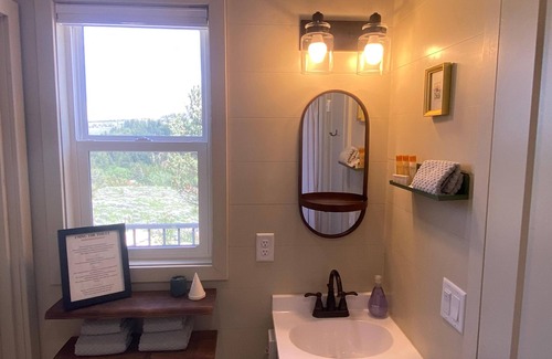 Red Lodge House | Our comfortable tiny cabin features Big amenities: Plush queen bed, galley kitchen, T.V., Internet, Fireplace & private bathroom, with shower & composting toilet. Large deck with seating areas, Bbq grill, table with umbrella & chairs. Plus lots of Vi