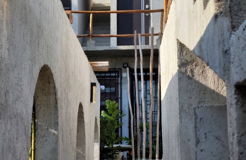 Chuburna Puerto Cottage | Pasilla suite. Ocean view glass doors to the turquoise water, 13foot Tv screen