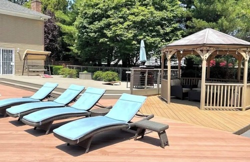 Shirley House | Peaceful Beach Retreat - Heated Pool, Big Backyard, Mini-Bar & Game Room