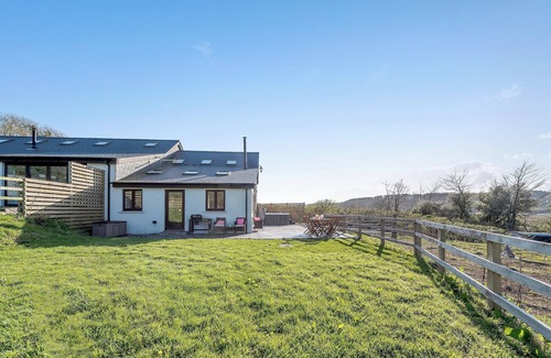 Ferryside Cottage | Picked for its luxury finish inside, stunning estuary views and a private hot tub.