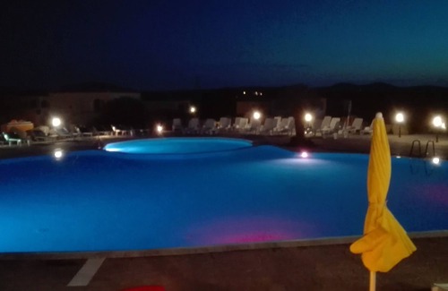Aglientu Apartment | Pink house in residence with pool, wifi -air conditioner, near the sea