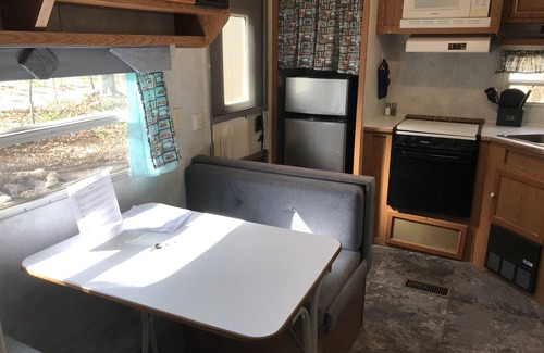Benzonia House | Platte - RV Camper in the Woods with Fire pit & Hot Tub Access