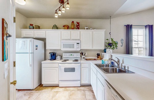 Sunset Beach Condo | Pond-front condo near beach with balcony, pool, & hot tub - snowbird-friendly
