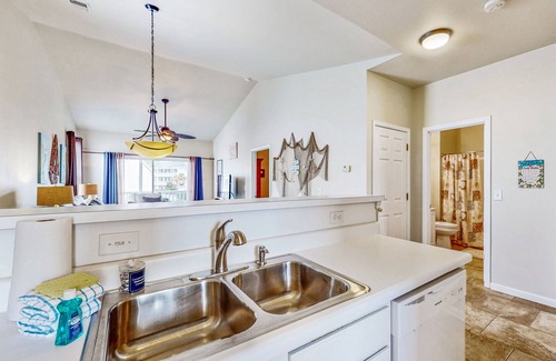 Sunset Beach Condo | Pond-front condo near beach with balcony, pool, & hot tub - snowbird-friendly