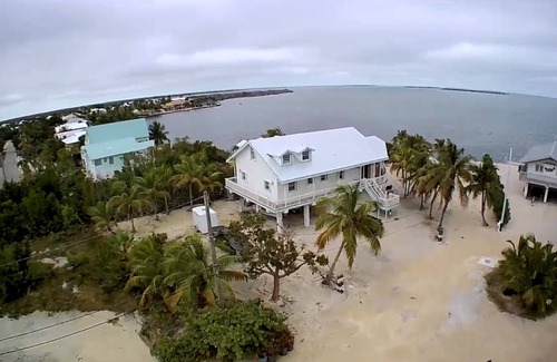 Doctor's Arm House | Pool house with open water and sunset in the Florida Keys