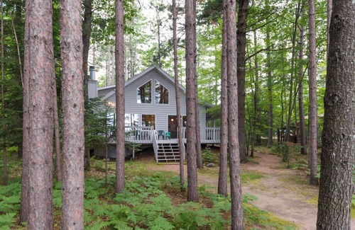 Eagle River House | Porch in the Pines | Lakefront home w/AC! Sandy Beach, Dock, Dogs OK