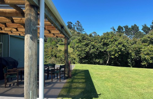 Richmond Downs House | Private Bach in Waihi Beach with stunning orchard views and beyond. Pet-friendly
