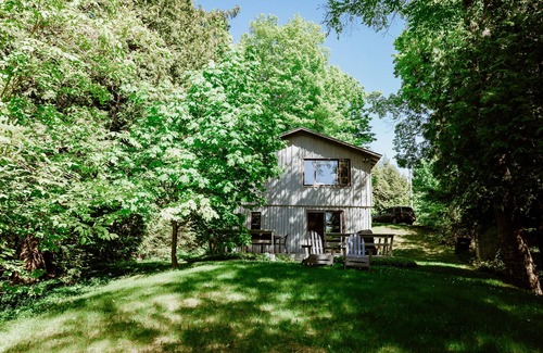 Lake Leelanau Cottage | Quaint cottage ON Lake Leelanau! Dock, deck, fire pit, large lawn!