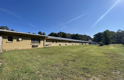 Mount Ida Apartment | Queen Guest Room located at the Joplin Inn at the entrance to Mountain Harbor, just 2 1/2 miles from Lake Ouachita. by RedAwning