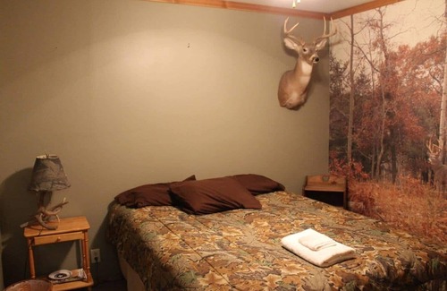 Thompsonville Cabin | Relax at Pond View Loft—your cozy barn-top retreat with pond views, fires, and fishing fun.