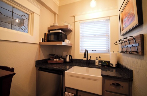 Historic Downtown District Apartment | Relax in the luxurious 1-bedroom Louisa Suite at RedTail Inn. Enjoy a double rain shower, plush linens, and a shared hot tub. Located near downtown Ashland, with off-street parking and high-speed WiFi.