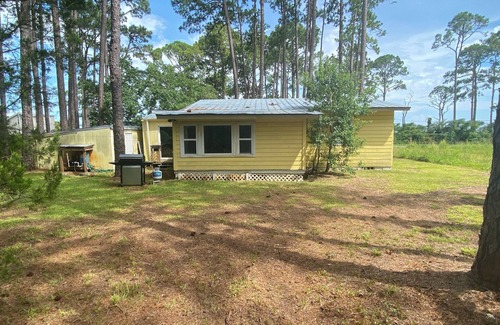 Carrabelle Cottage | Remodeled historic cottage with a peek of the Gulf of Mexico.