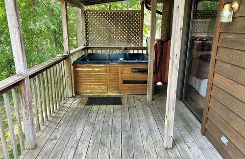 South Haven Cottage | Riverbend Retreat Middle Branch CottagenFireplace and hot tub with river view.