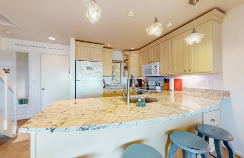 Maple City Condo | Riverfront condo near the lake with beach access, fireplace, balcony & cable