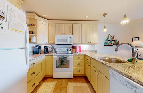Maple City Condo | Riverfront condo near the lake with beach access, fireplace, balcony & cable