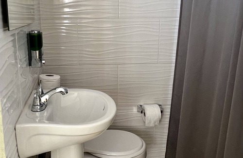 Higuey Hotel | Romantic Hispanic 304 private room with refrigerator and dining area.