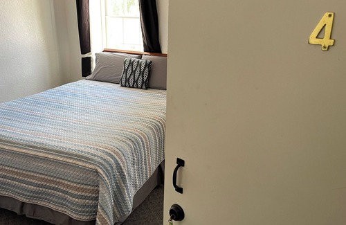 Spillville Apartment | Room 2: Sleep Where Prohibition Secrets Were Made - Historic Escape!
