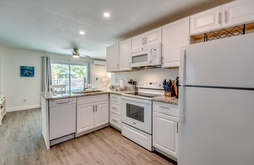 South Island House | Sand Dollar #1 - Downstairs Apt with Shared Pool on Canal by the Beach!