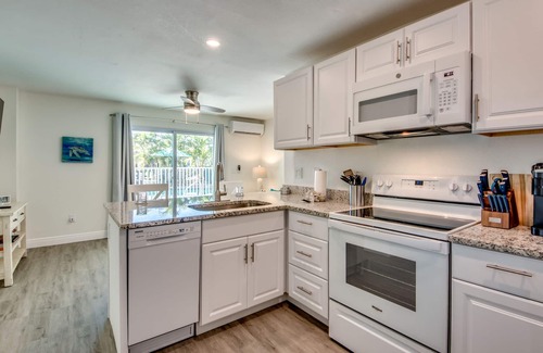 South Island House | Sand Dollar #1 - Downstairs Apt with Shared Pool on Canal by the Beach!