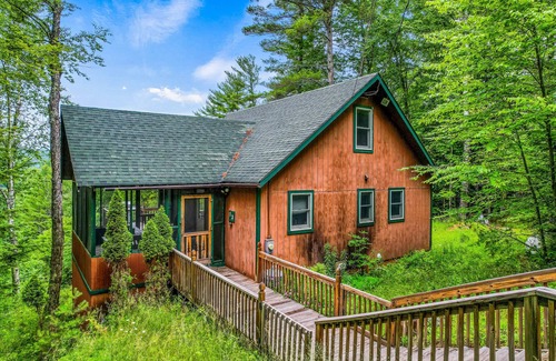 Brant Lake House | Secluded cabin with dock, wraparound deck, gorgeous view & enclosed porch