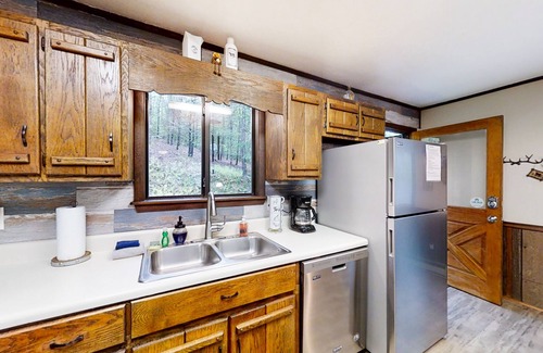 Murphy House | Secluded home with deck, firepit, sunroom, gas fireplace, & W/D
