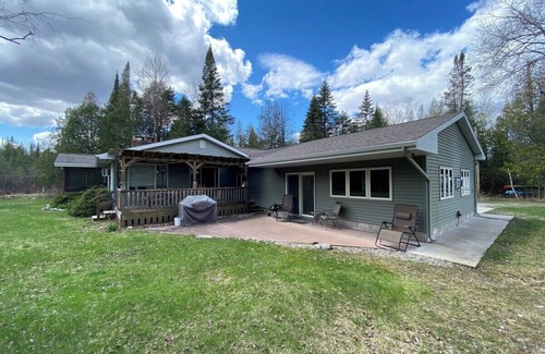 Grayling House | Secluded Riverfront Home in Grayling