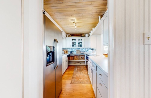 Royal Lagoons House | Serene sound-front home with a covered patio, dock, and swing bed