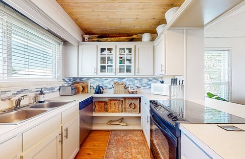 Royal Lagoons House | Serene sound-front home with a covered patio, dock, and swing bed