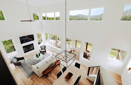 Young Harris Cabin | Serenity Now is a 4BR/3.5BA mountain retreat where fall shines. Gather by the gas fireplace, share meals in open living spaces, and relax on a large deck with sweeping views and changing leaves. Perfect for families, friends, or couples.