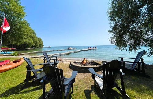 Big Bay Point Cottage | Shallow Beach Lakefront Cottage perfect with Kayak, Firepit, BBQ + Playground