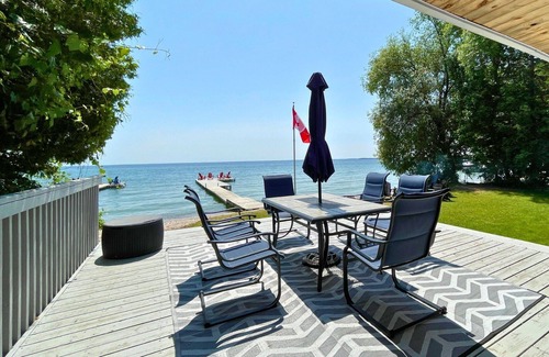 Big Bay Point Cottage | Shallow Beach Lakefront Cottage perfect with Kayak, Firepit, BBQ + Playground