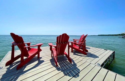 Big Bay Point Cottage | Shallow Beach Lakefront Cottage perfect with Kayak, Firepit, BBQ + Playground