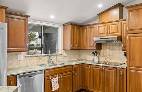 Fillmore House | Single-level home surrounded by lush gardens with a washer/dryer, AC, & wet bar