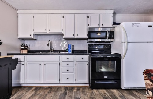 St Germain Cabin | Snowy lake-view cabin with fireplace, full kitchen, TV, dock, & DVD player