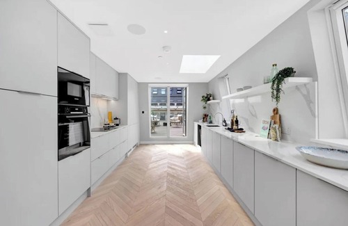 Fitzrovia Condo | Soak in the Spalike Marble Bath at Plush Penthouse