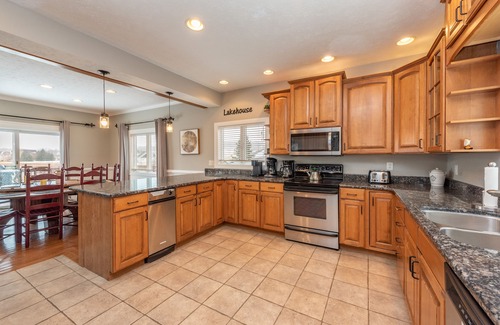 Waterfront Greens House | Spacious Lake Retreat w/Hot Tub & Fireplace