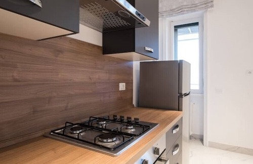 Esquilino Apartment | Spacious penthouse with gym in historic building, near the Colosseum