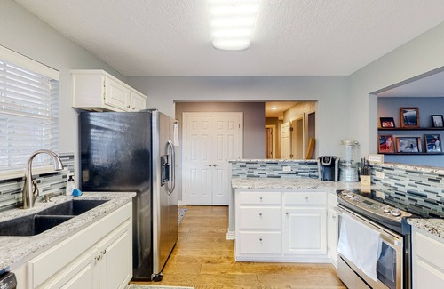 Garfield House | Spacious waterfront home with a washer/dryer, central AC & deck