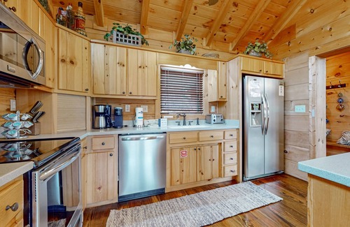 Big Creek Cabin | Spacious waterfront property with deck, hot tub, fireplace, & central AC