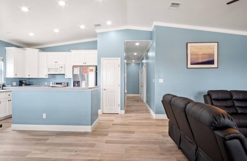 Leeward Sands House | "Step into Shark Attacks and embrace the coastal charm, setting the scene for a refreshing escape. With a spacious open floor plan, it's perfect for family gatherings and unforgettable memories."