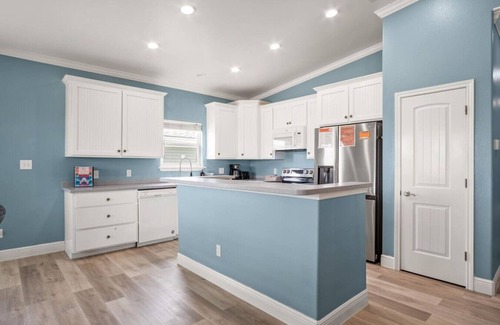 Leeward Sands House | "Step into Shark Attacks and embrace the coastal charm, setting the scene for a refreshing escape. With a spacious open floor plan, it's perfect for family gatherings and unforgettable memories."