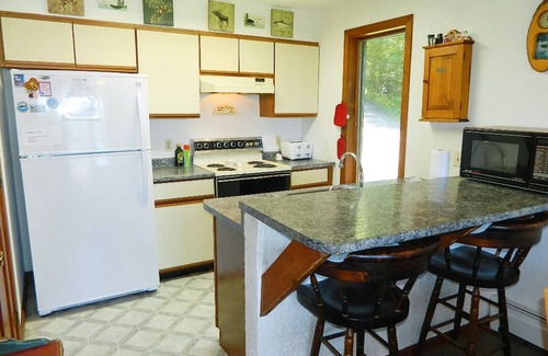 Rangeley House | Stone - This Rangeley Lake home has a very level entry to the water with a huge deck!